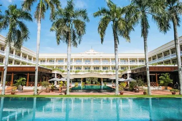 Victoria Can Tho Resorts lyse facade og palmer set fra poolen